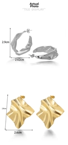 Detail view of gold and silver irregular pleated metal earrings with exact size markings