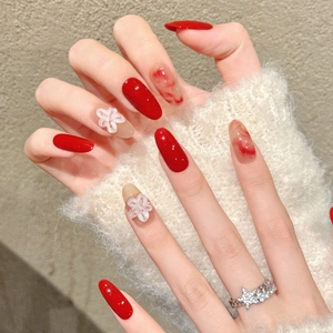 Long oval red press-on nails with 3D white flowers and marble effect texture