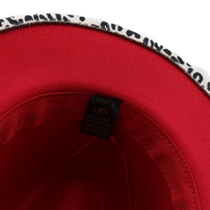 Detail of red fedora inner lining with grosgrain sweatband and leopard print edge trim