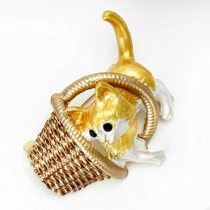 Detail of cute cat playing with a woven basket enamel brooch in white and gold