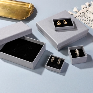 Detailed top view of grey jewelry boxes for rings and earrings with black foam inserts