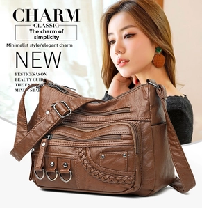 Detail of dark brown faux leather woven crossbody bag with multiple zip pockets