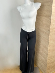 Detail of white ribbed tank top and black drawstring wide leg trousers on a mannequin