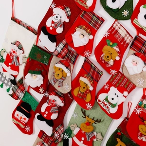 Detail view of assorted Christmas stockings featuring Santa, snowman, and reindeer designs