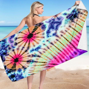 Microfiber tie-dye beach towel featuring vibrant colors displayed in a sunny beach setting