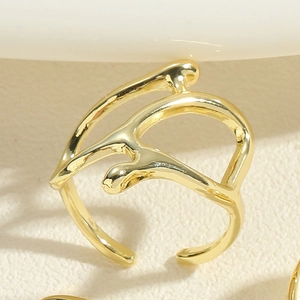 Detailed macro shot of a gold irregular organic open ring with smooth polished finish