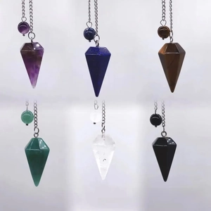 Macro view of hexagonal natural crystal pendant set including amethyst and lapis lazuli