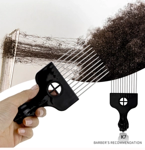 K7 metal Afro pick comb with black fist handle being used on curly hair by a barber