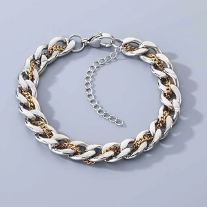 Detail of silver and gold toned interlocking cuban chain bracelet with lobster clasp