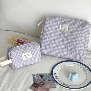 Detailed macro view of two lilac checkered quilted cotton cosmetic bags in different sizes