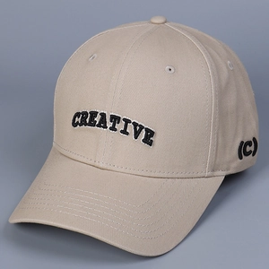 Macro detail of 3D CREATIVE letter embroidery on khaki cotton twill baseball cap