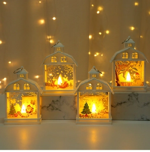 Detail of Christmas white house lanterns with warm LED candles on marble decor