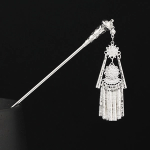 Detailed view of silver ethnic hair pin with intricate Miao tassels and filigree work
