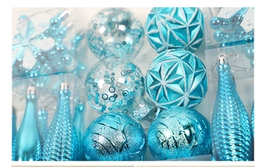 Detailed close-up of ice blue and silver Christmas tree ornaments in varied textures