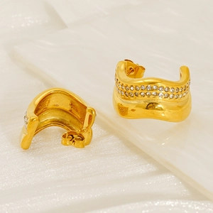 Detail of gold-plated C-shaped earrings with double row of zircons and wave pattern