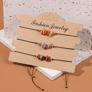 Three handmade natural crystal stone bracelets on craft card with black braided cords