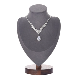 Floral silver necklace with teardrop crystal on gray bust mannequin and walnut wood base