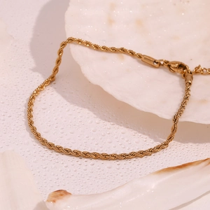 Minimalist 18K gold plated 2mm twist chain anklet with lobster clasp on a white background