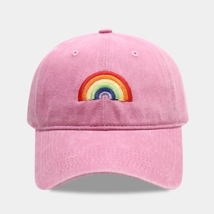 Pink cotton baseball cap featuring colorful rainbow embroidery and adjustable strap