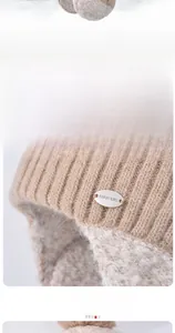Detail view of winter earflap hat with thick white plush lining and soft knitted texture