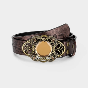 Detail of vintage embossed leather belt with ornate bronze buckle and amber gemstone
