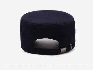 Detail of adjustable metal buckle and strap on the back of a navy cotton flat cap