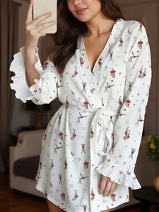 Detail of white women's robe featuring red rabbit prints and ruffled cuffs with waist tie