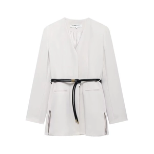 Detail of off-white minimalist blazer with black leather belt and gold metal tips
