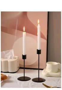 Close-up of minimalist black matte metal candle holders for elegant home dining decor