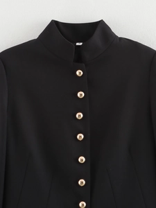 Detail shot of navy slim fit blazer showing gold metal buttons and twill fabric texture