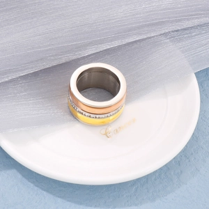 Macro detail of tricolor zircon ring with gold, silver and rose gold polished finishes