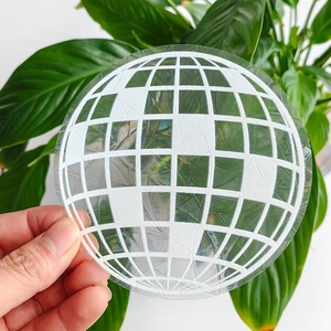 Close-up of a circular rainbow suncatcher film featuring a white globe grid design
