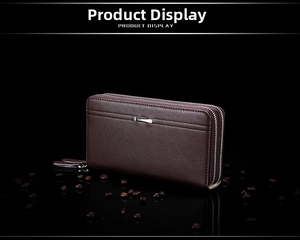 Detail of dark brown leather long wallet with litchi texture and double zipper on black surface