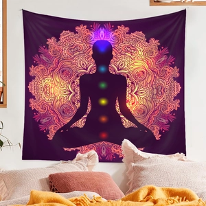 Detail of meditation tapestry with chakra silhouette and mandala pattern on wall