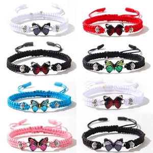 Close-up of colorful butterfly charm bracelets with adjustable braided ropes in multi-colors