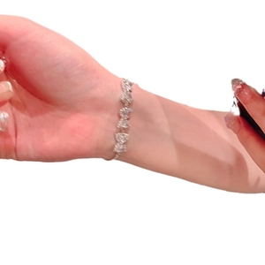 Elegant silver heart-shaped zircon bracelet for women worn on wrist in a clean style