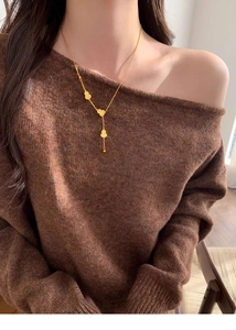 Detailed view of the 18k gold plated gourd pendants on a delicate Y-shaped necklace chain