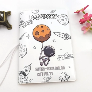 Close-up of a white passport holder with cartoon astronaut theme and floral decoration