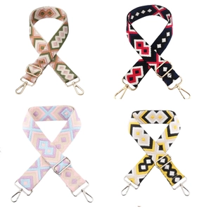 Detail of four colorful bohemian embroidered bag straps with metallic buckles