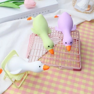 Three cute squeeze duck stress relief toys in white, green and purple colors