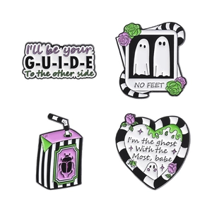 Set of four Beetlejuice style enamel pins with ghost motifs and black white stripes
