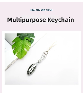 Macro detail of silver metal multi-purpose ring clasp attached to a car key with woven cord