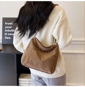 Brown corduroy shoulder bag detail showing vertical stripe texture and soft design