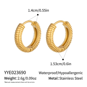Detail of 18K gold plated stainless steel hoop earrings with spiral striped texture