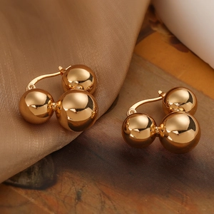 Elegant gold plated triple bead geometric earrings on premium satin background