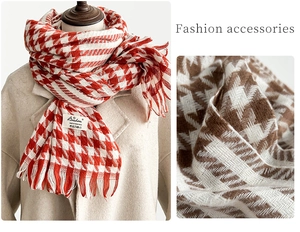 Detail of red and brown houndstooth scarves with tassel trim and soft cashmere-like texture