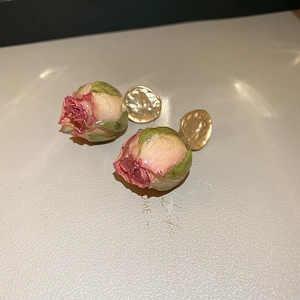 Detail showing real dried rose flower resin earrings with vintage hammered gold base