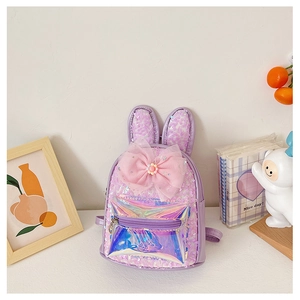 Detail of purple sequin kids backpack with bunny ears, large pink bow and holographic pocket