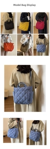 Detailed close-up of a quilted tote bag featuring a diamond pattern and side zipper pocket