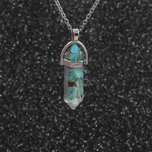 Macro view of blue and brown stone chips inside a hexagonal crystal bullet pendant